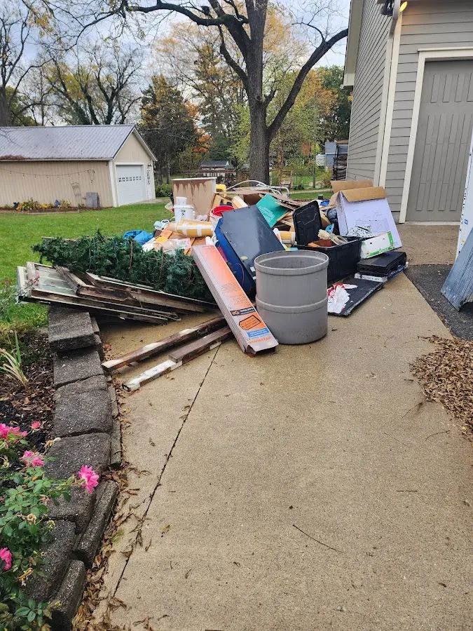 Dumpster being loaded with debris for Estate Cleanout Dumpster Rental in Rockford